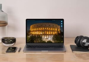 Come Trovare Lavoro Da Remoto a Roma: Opportunità e Consigli 13 laptop su scrivania con vista colosseo