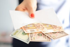 mani che passano una busta con soldi